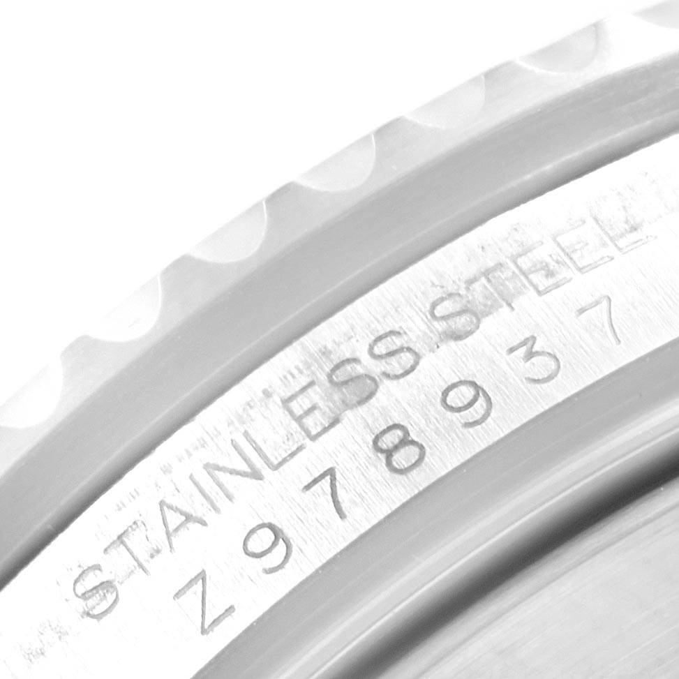 The image shows a close-up angle of the bezel and case rim of the Rolex Submariner 16610 Men's Stainless Steel Silver Dial 16610 Men's Stainless Steel Silver Dial, highlighting the "STAINLESS STEEL" engraving and serial number.