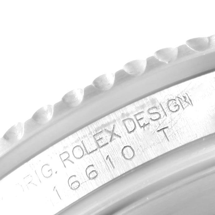 The image shows a close-up of the bezel and serial engraving on a Rolex Submariner 16610 Men's Stainless Steel Black Dial 16610 Men's Stainless Steel Black Dial watch.