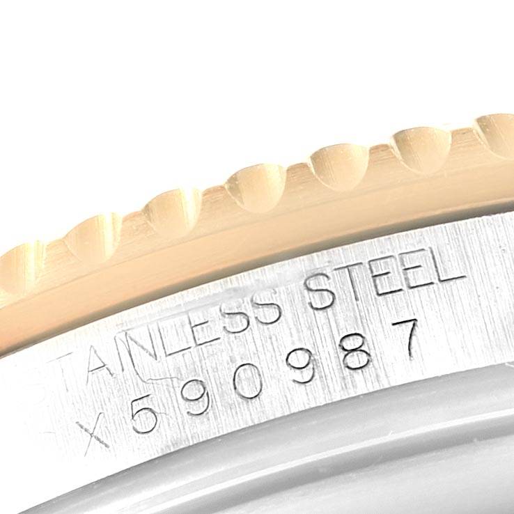 The image shows a close-up of the bezel and part of the casing with the serial number of a Rolex Submariner 16613 Men's Steel and Gold (two tone) Black Dial 16613 Men's Steel and Gold (two tone) Black Dial watch.