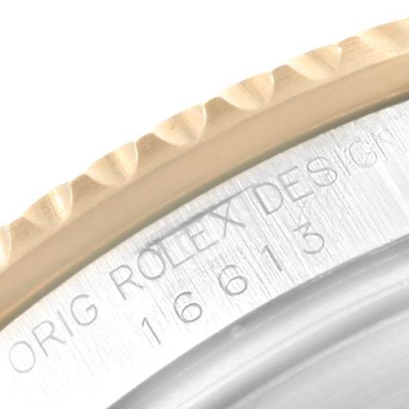 This close-up image shows the case edge and model number engraving of a Rolex Submariner 16613 Men's Steel and Gold (two tone) Black Dial 16613 Men's Steel and Gold (two tone) Black Dial watch.