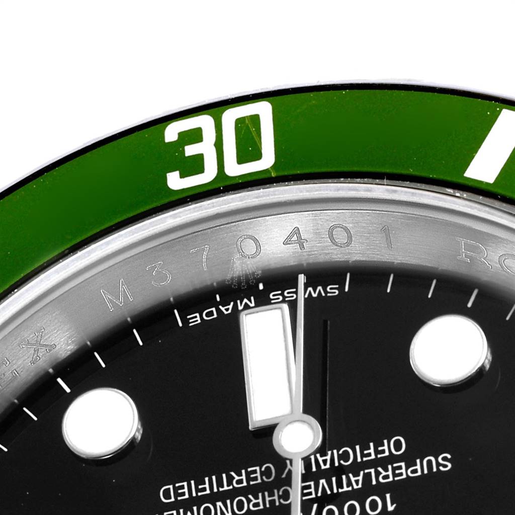 This close-up shows the bezel, part of dial, markings, and minute hand of the Rolex Submariner 16610LV Men's Stainless Steel Black Dial 16610LV Men's Stainless Steel Black Dial watch.