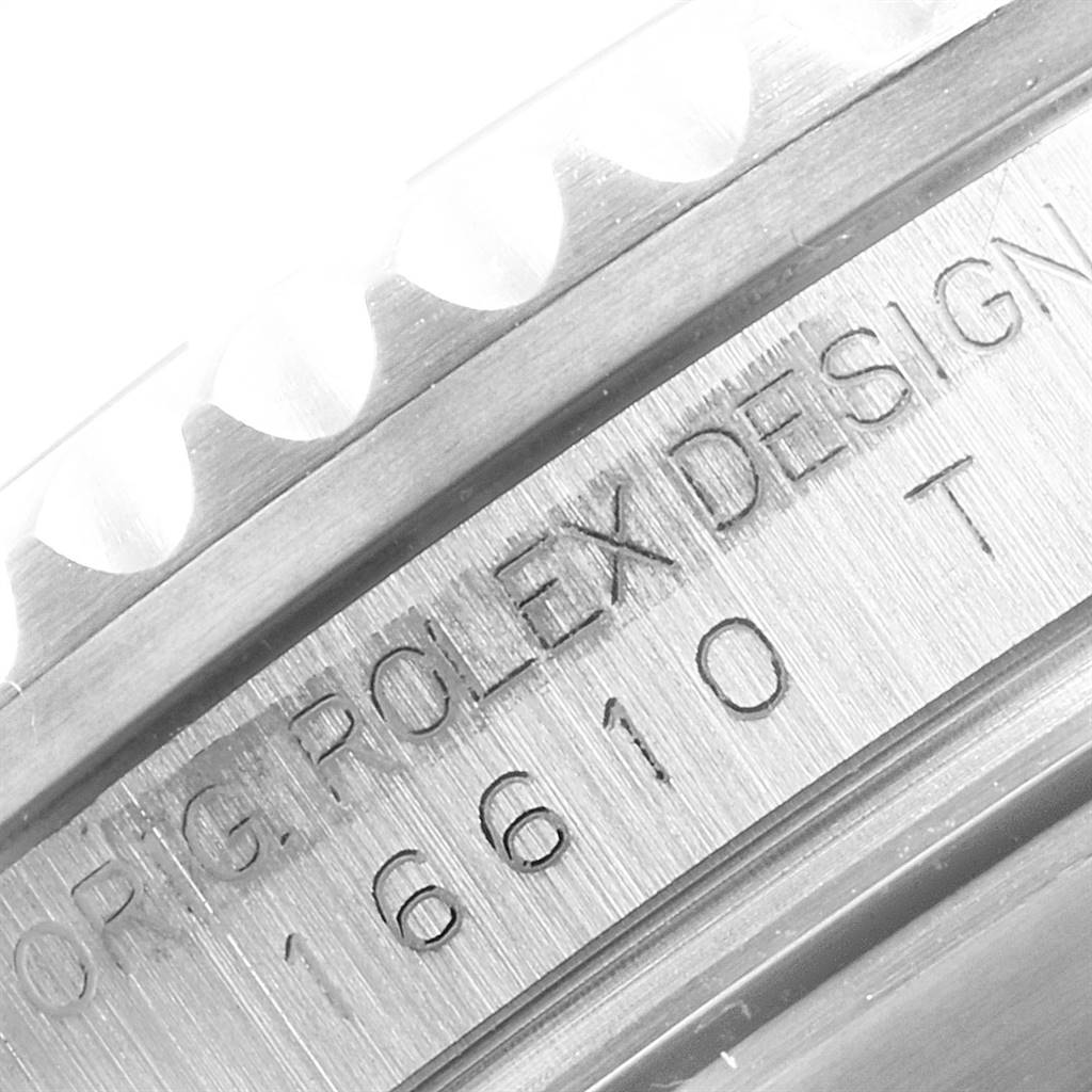 This image shows a close-up of the Rolex Submariner 16610 Men's Stainless Steel Black Dial 16610 Men's Stainless Steel Black Dial model's engraved inner bezel and case.