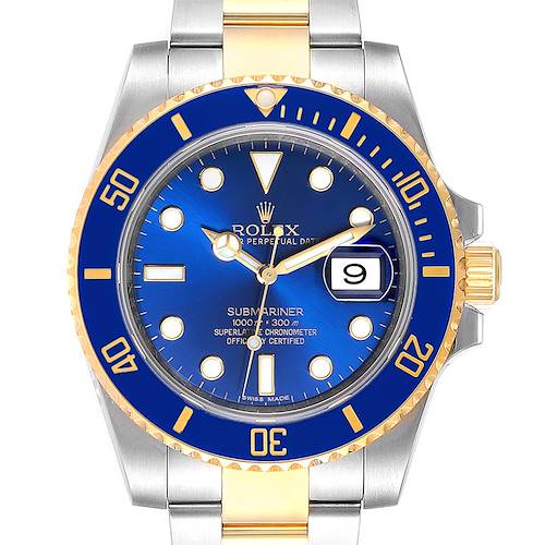 This close-up shows the dial, bezel, crown, and part of the bracelet of the Rolex Submariner 116613 Men's Steel and Gold (two tone) Blue Dial 116613 Men's Steel and Gold (two tone) Blue Dial.