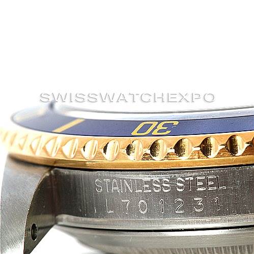 This image shows a close-up of the side profile of the Rolex Submariner 16613 Men's Steel and Gold (two tone) Blue Dial 16613 Men's Steel and Gold (two tone) Blue Dial, focusing on the bezel and engraving on the stainless steel case.