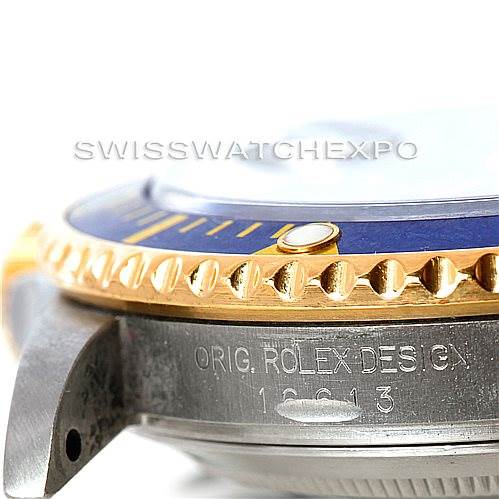 This close-up angle shows the side of a Rolex Submariner 16613 Men's Steel and Gold (two tone) Blue Dial 16613 Men's Steel and Gold (two tone) Blue Dial, focusing on its bezel and case with the model number engraved.