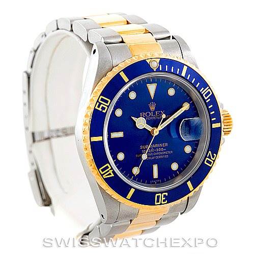 The image shows a Rolex Submariner 16613 Men's Steel and Gold (two tone) Blue Dial 16613 Men's Steel and Gold (two tone) Blue Dial watch with a blue dial, gold and silver bracelet, angled slightly from the front-left side.
