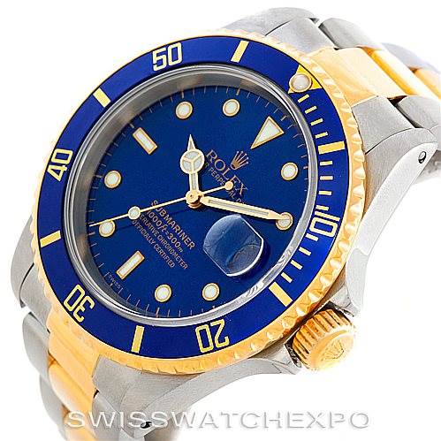 This image shows a close-up of a Rolex Submariner 16613 Men's Steel and Gold (two tone) Blue Dial 16613 Men's Steel and Gold (two tone) Blue Dial watch, featuring its blue dial, gold accents, and bi-metal band.