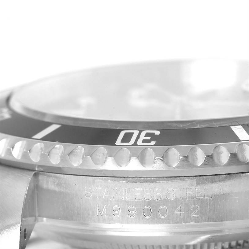 This close-up image shows the bezel and engraved case side of a Rolex Submariner 16610 Men's Stainless Steel Black Dial 16610 Men's Stainless Steel Black Dial watch.