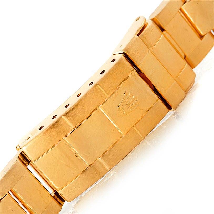 This image shows a close-up of the gold bracelet clasp of a Rolex Submariner 16618 Men's Yellow Gold Blue Dial 16618 Men's Yellow Gold Blue Dial watch at an angled view.