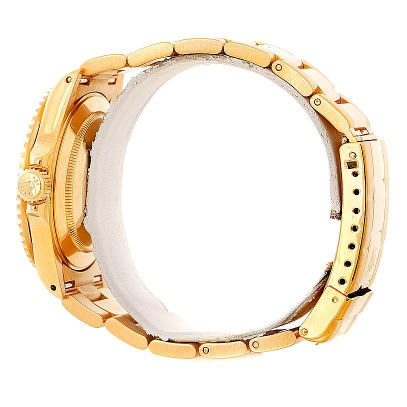 This image shows the side view of a Rolex Submariner 16618 Men's Yellow Gold Blue Dial 16618 Men's Yellow Gold Blue Dial watch, specifically highlighting the crown, case, and bracelet links.