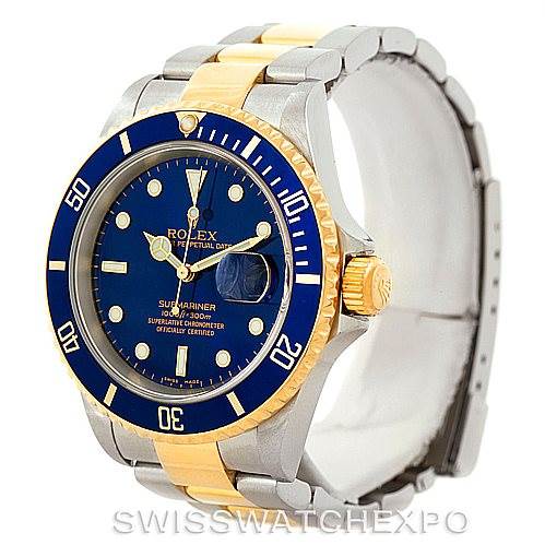 The image displays a Rolex Submariner 16613 Men's Steel and Gold (two tone) Blue Dial 16613 Men's Steel and Gold (two tone) Blue Dial watch from an angled front view, highlighting its blue dial, bezel, and two-tone bracelet.