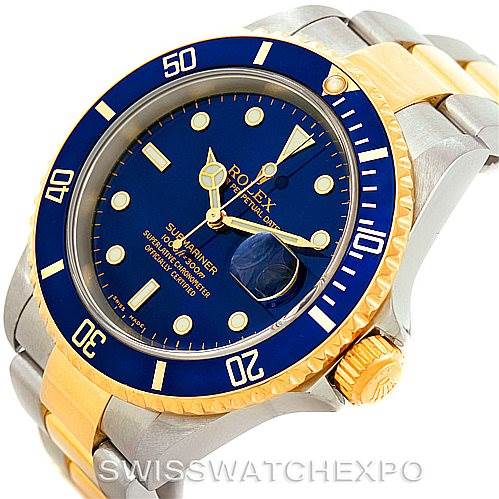 This image shows a Rolex Submariner 16613 Men's Steel and Gold (two tone) Blue Dial 16613 Men's Steel and Gold (two tone) Blue Dial watch from an angled perspective, highlighting its blue dial, date display, and two-tone bracelet.