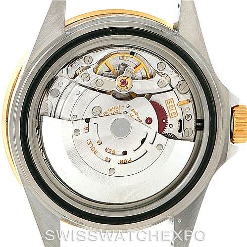 The image shows the open case back of a Rolex Submariner 16613 Men's Steel and Gold (two tone) Blue Dial 16613 Men's Steel and Gold (two tone) Blue Dial, revealing its internal movement components.