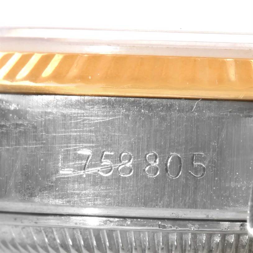 The close-up image shows the serial number engraved on the case of a Rolex Datejust 69173 Women's Stainless Steel Blue Dial 69173 Women's Stainless Steel Blue Dial watch.