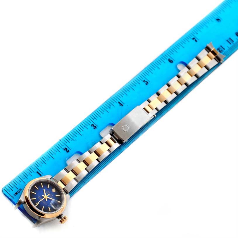 The image shows a Rolex Datejust 79163 Women's Steel and Gold (two tone) Blue Dial 79163 Women's Steel and Gold (two tone) Blue Dial watch laid flat with a blue ruler, highlighting the bracelet and clasp.