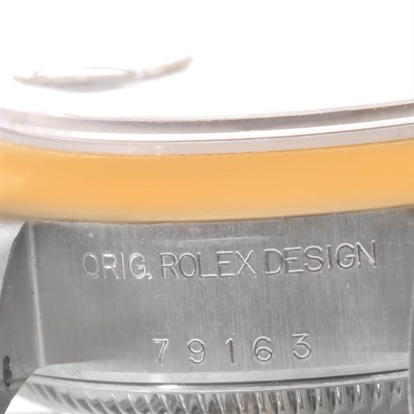 The image shows a close-up angle of the side of a Rolex Datejust 79163 Women's Steel and Gold (two tone) Blue Dial 79163 Women's Steel and Gold (two tone) Blue Dial watch case, featuring the model number 79163 and "ORIG. ROLEX DESIGN."