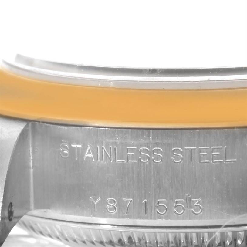 The image shows a close-up of the stainless steel case side of a Rolex Datejust 79163 Women's Steel and Gold (two tone) Blue Dial 79163 Women's Steel and Gold (two tone) Blue Dial with part of the serial number and bezel visible.