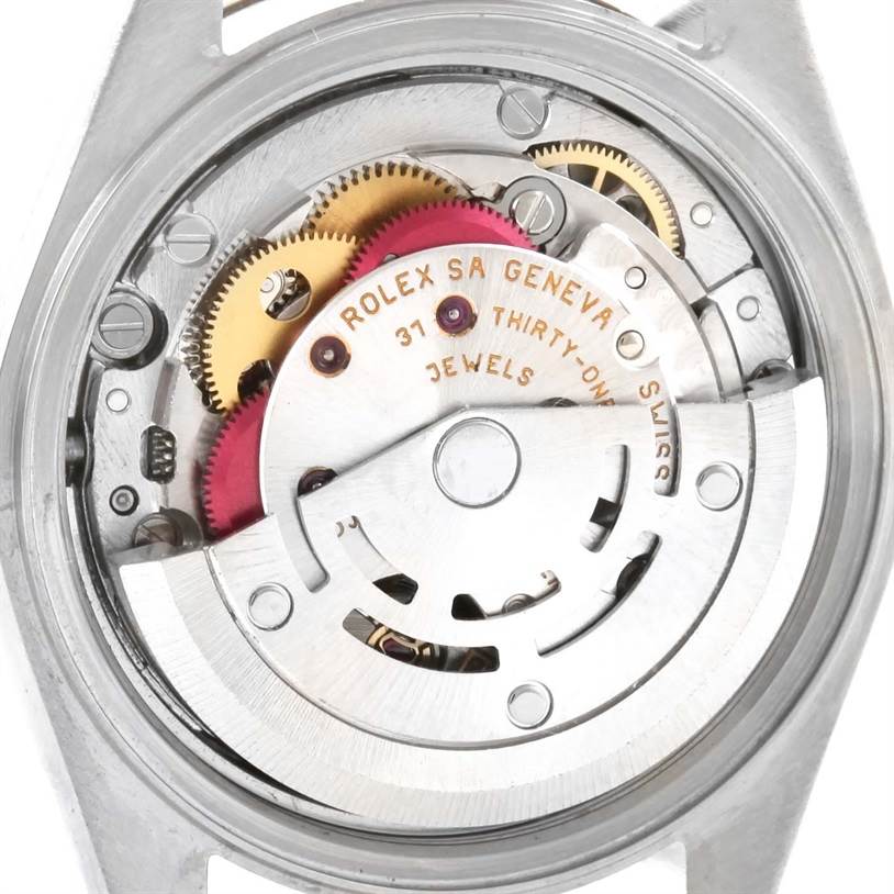 This is a close-up view of the Datejust model by Rolex showing its exposed movement and internal mechanical components.