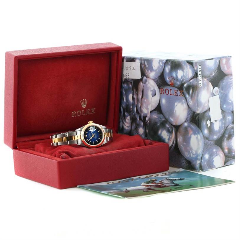 The image shows a Rolex Datejust 79163 Women's Steel and Gold (two tone) Blue Dial 79163 Women's Steel and Gold (two tone) Blue Dial watch inside its red box, alongside the packaging box and a booklet.