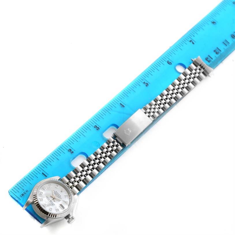 The image shows a Rolex Datejust 79174 Women's Stainless Steel Mother of Pearl Dial 79174 Women's Stainless Steel Mother of Pearl Dial watch face and bracelet alongside a blue ruler, photographed from a top-down angle.