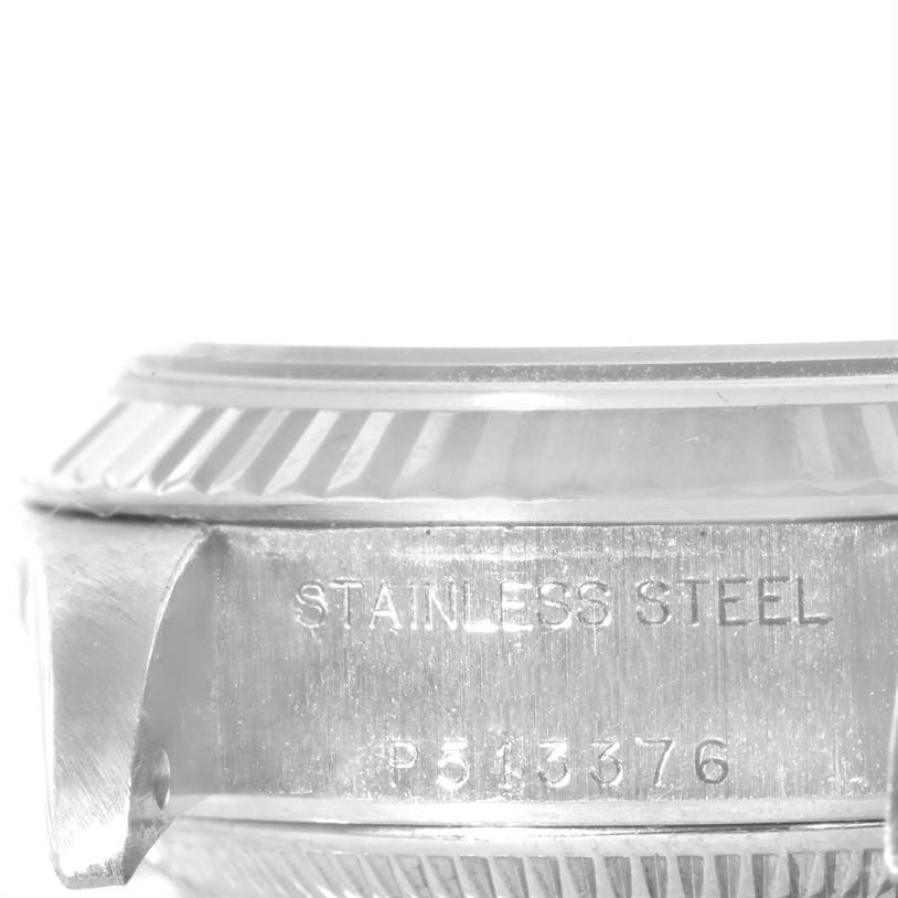 The image shows a close-up side view of the stainless steel case and bezel of a Rolex Datejust 79174 Women's Stainless Steel Mother of Pearl Dial 79174 Women's Stainless Steel Mother of Pearl Dial watch, including part of the serial number.