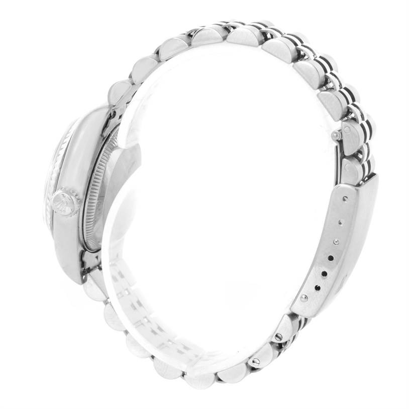 This side angle view of the Rolex Datejust 79174 Women's Stainless Steel Mother of Pearl Dial 79174 Women's Stainless Steel Mother of Pearl Dial watch showcases the case, bezel, crown, and bracelet.