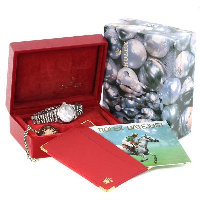 The image shows a Rolex Datejust 79174 Women's Stainless Steel Mother of Pearl Dial 79174 Women's Stainless Steel Mother of Pearl Dial watch inside its open box, accompanied by a booklet and packaging.