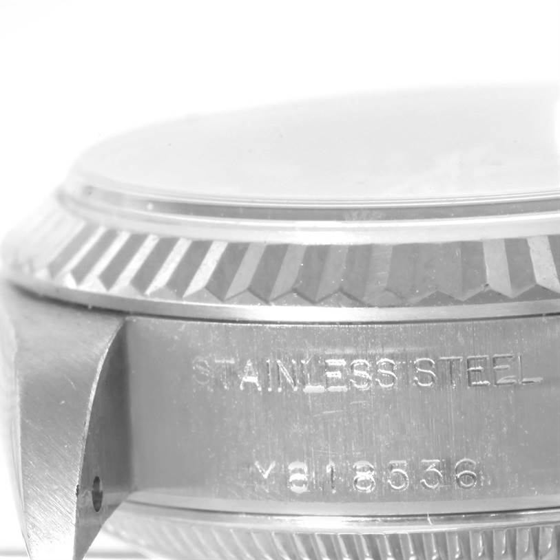 This image shows a close-up side view of a stainless steel case of a Rolex Datejust 79174 Women's Stainless Steel Blue Dial 79174 Women's Stainless Steel Blue Dial watch, highlighting the serial number and edge of the bezel.