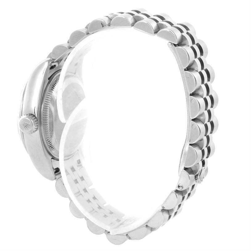 The image shows a side view of a Rolex Datejust 179174 Women's Stainless Steel Mother of Pearl Dial 179174 Women's Stainless Steel Mother of Pearl Dial watch, highlighting its case, crown, and metal bracelet.