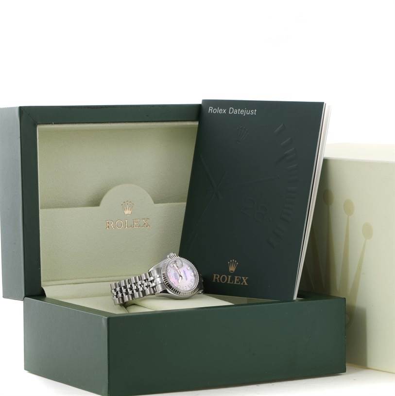 The image shows a Rolex Datejust 179174 Women's Stainless Steel Mother of Pearl Dial 179174 Women's Stainless Steel Mother of Pearl Dial watch and its box, along with the user manual, viewed at a slight angle.