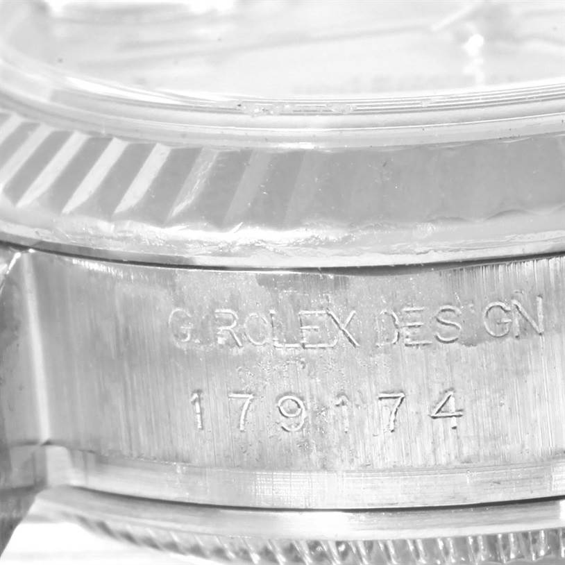 This is a close-up shot of a Rolex Datejust 179174 Women's Stainless Steel Mother of Pearl Dial 179174 Women's Stainless Steel Mother of Pearl Dial showing the engraved model number and part of the fluted bezel.