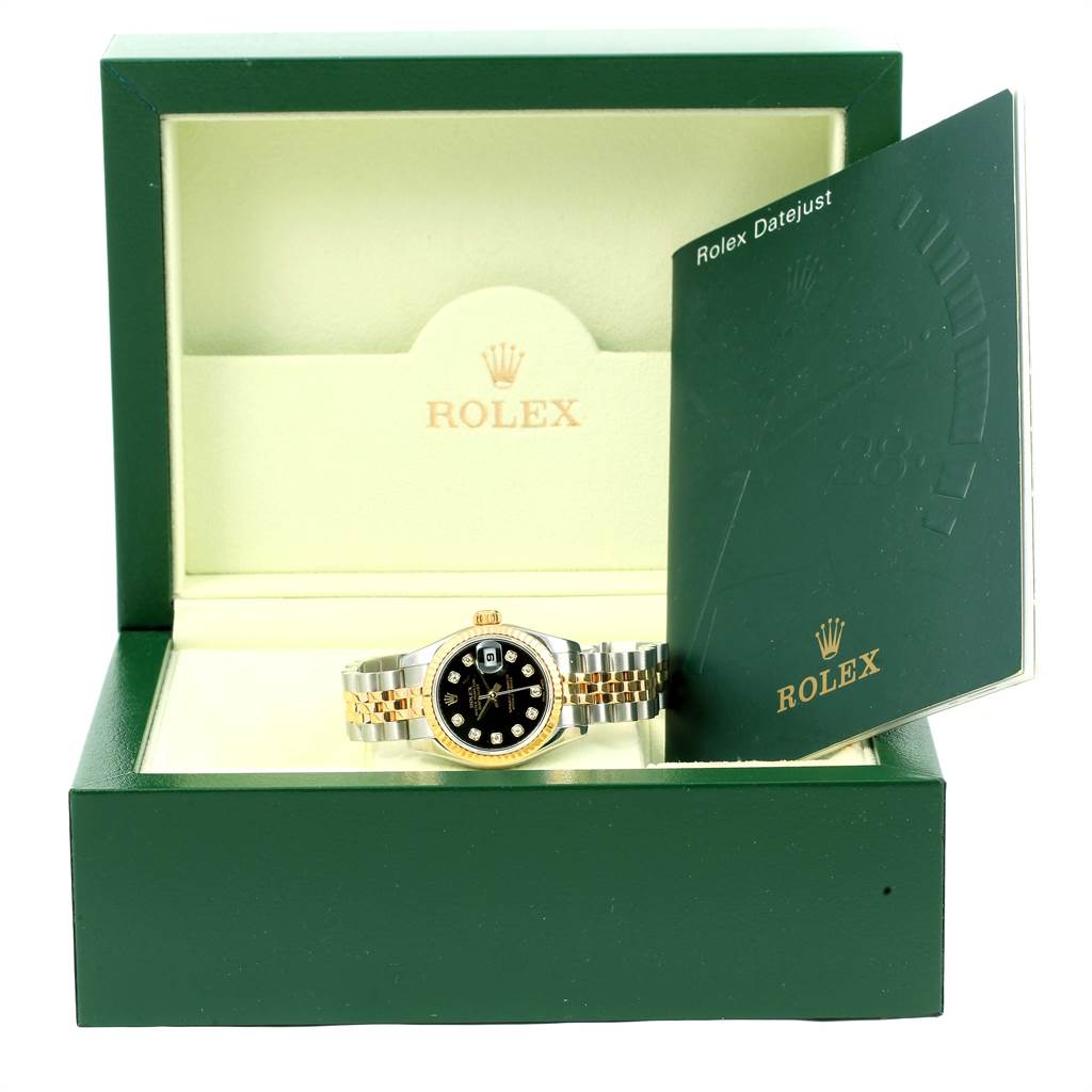 The image shows a Rolex Datejust 179173 Women's Steel and Gold (two tone) Black Dial 179173 Women's Steel and Gold (two tone) Black Dial watch in its green box with an open instruction booklet on the right.