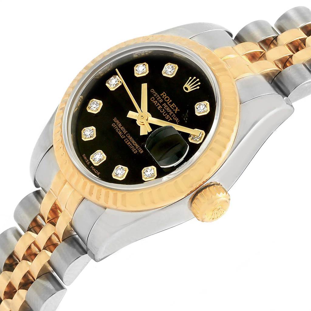 The image shows a close-up of a Rolex Datejust 179173 Women's Steel and Gold (two tone) Black Dial 179173 Women's Steel and Gold (two tone) Black Dial watch, highlighting its black dial, diamond hour markers, gold bezel, and two-tone bracelet.