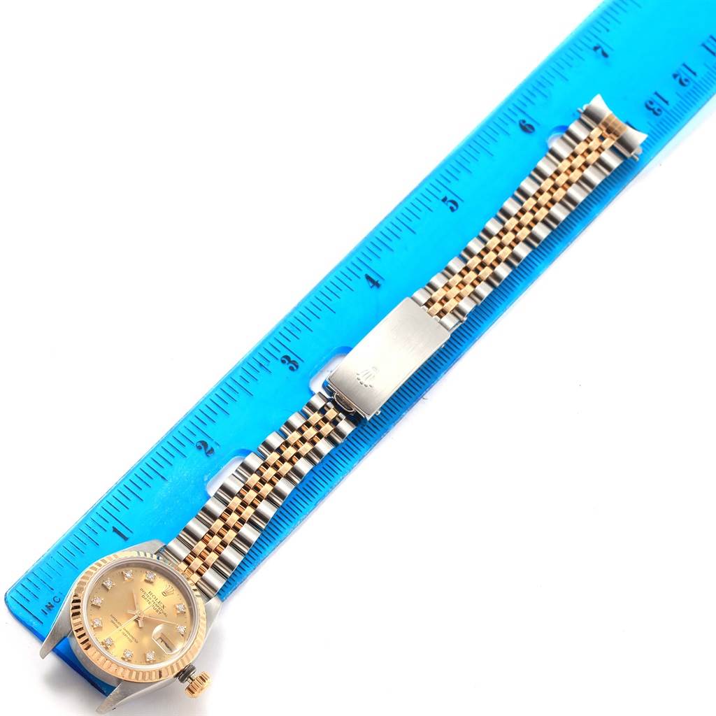 The image shows a Rolex Datejust 69173 Women's Stainless Steel Champagne Dial 69173 Women's Stainless Steel Champagne Dial watch with a partial front view, highlighting the face and band, measured against a blue ruler.