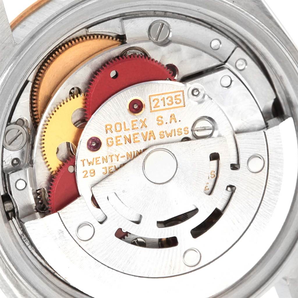This image displays the inner mechanical movement of a Rolex Datejust 69173 Women's Stainless Steel Champagne Dial 69173 Women's Stainless Steel Champagne Dial watch, model 2135, showcasing gears and intricate components.