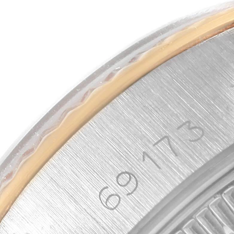 This close-up image of a Rolex Datejust 69173 Women's Stainless Steel White Dial 69173 Women's Stainless Steel White Dial watch shows part of the bezel and the engraved model number 69173.