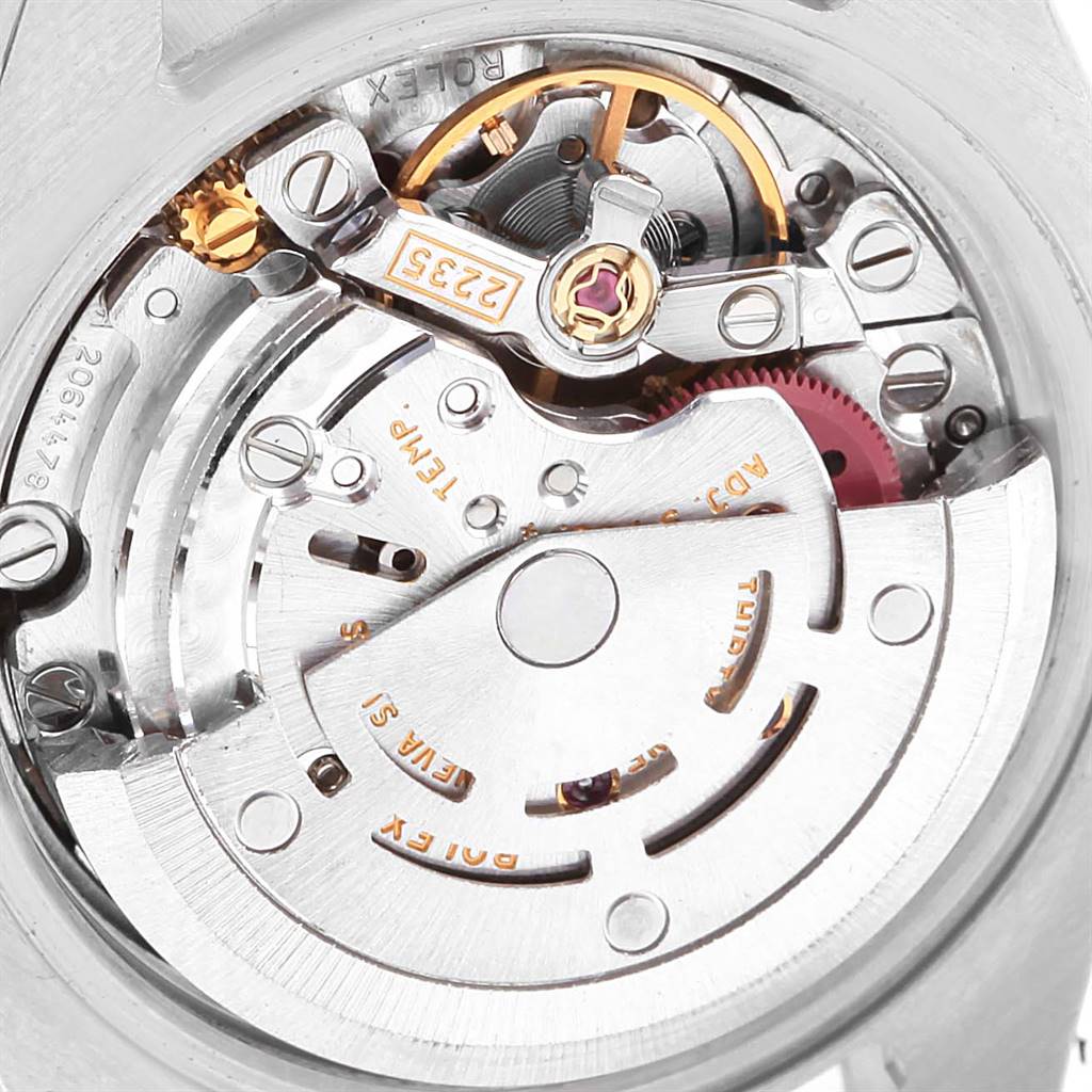 This image shows a close-up view of the Rolex Datejust 179161 Women's Steel and Gold (two tone) Pink Dial 179161 Women's Steel and Gold (two tone) Pink Dial watch's intricate internal movement and mechanism components.