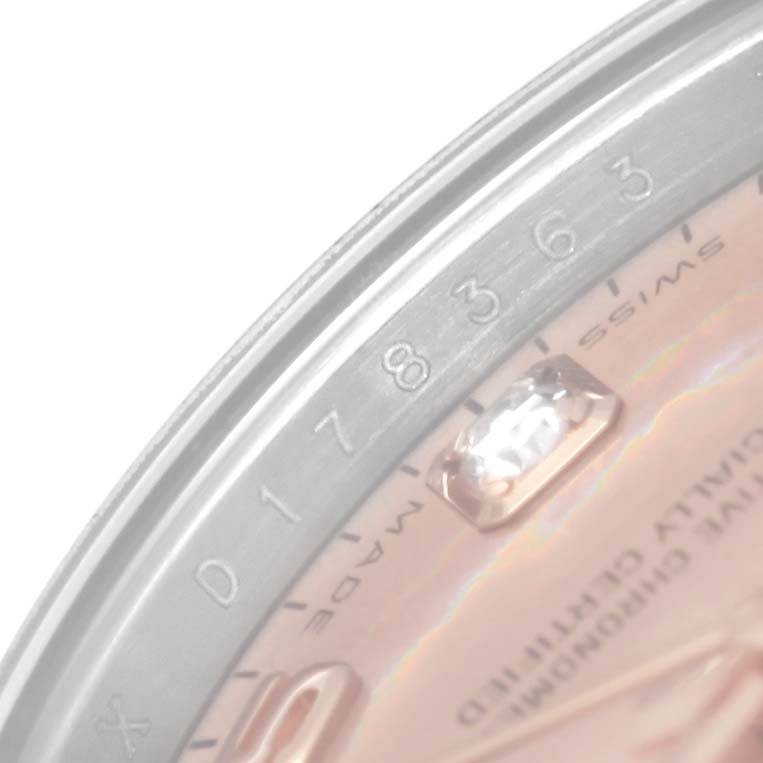 Close-up of the Rolex Datejust 179161 Women's Steel and Gold (two tone) Pink Dial 179161 Women's Steel and Gold (two tone) Pink Dial watch showing a partial view of the dial, diamond marker, and the edge of the bezel.