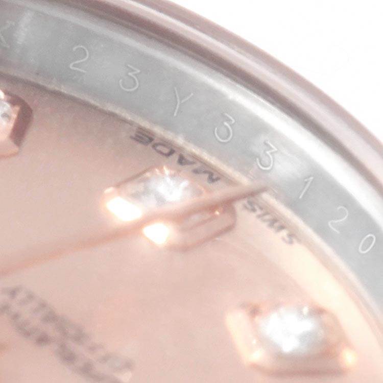 This close-up image shows the dial and part of the bezel of a Rolex Datejust 179171 Women's Steel and Gold (two tone) Pink Dial 179171 Women's Steel and Gold (two tone) Pink Dial watch.
