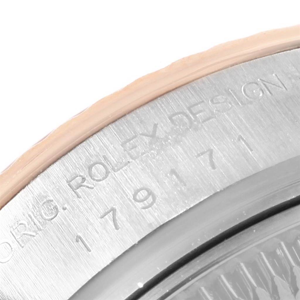 This image shows a close-up of the case back of a Rolex Datejust 179171 Women's Steel and Gold (two tone) Pink Dial 179171 Women's Steel and Gold (two tone) Pink Dial watch, displaying part of the serial number and "ROLEX DESIGN" engraving.