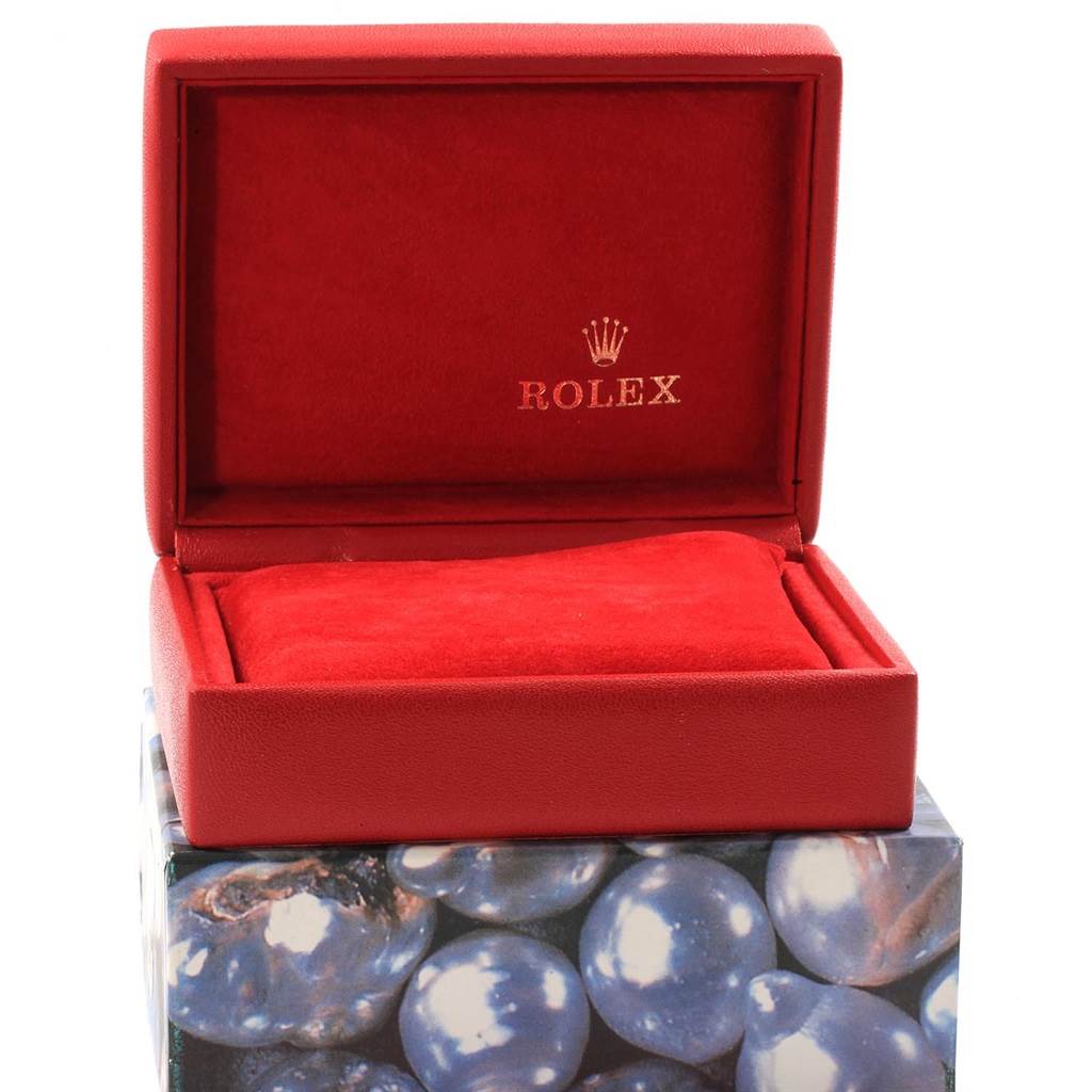 This image shows an open red Rolex Datejust 79173 Women's Steel and Gold (two tone) White Dial 79173 Women's Steel and Gold (two tone) White Dial watch box with a red cushion inside.