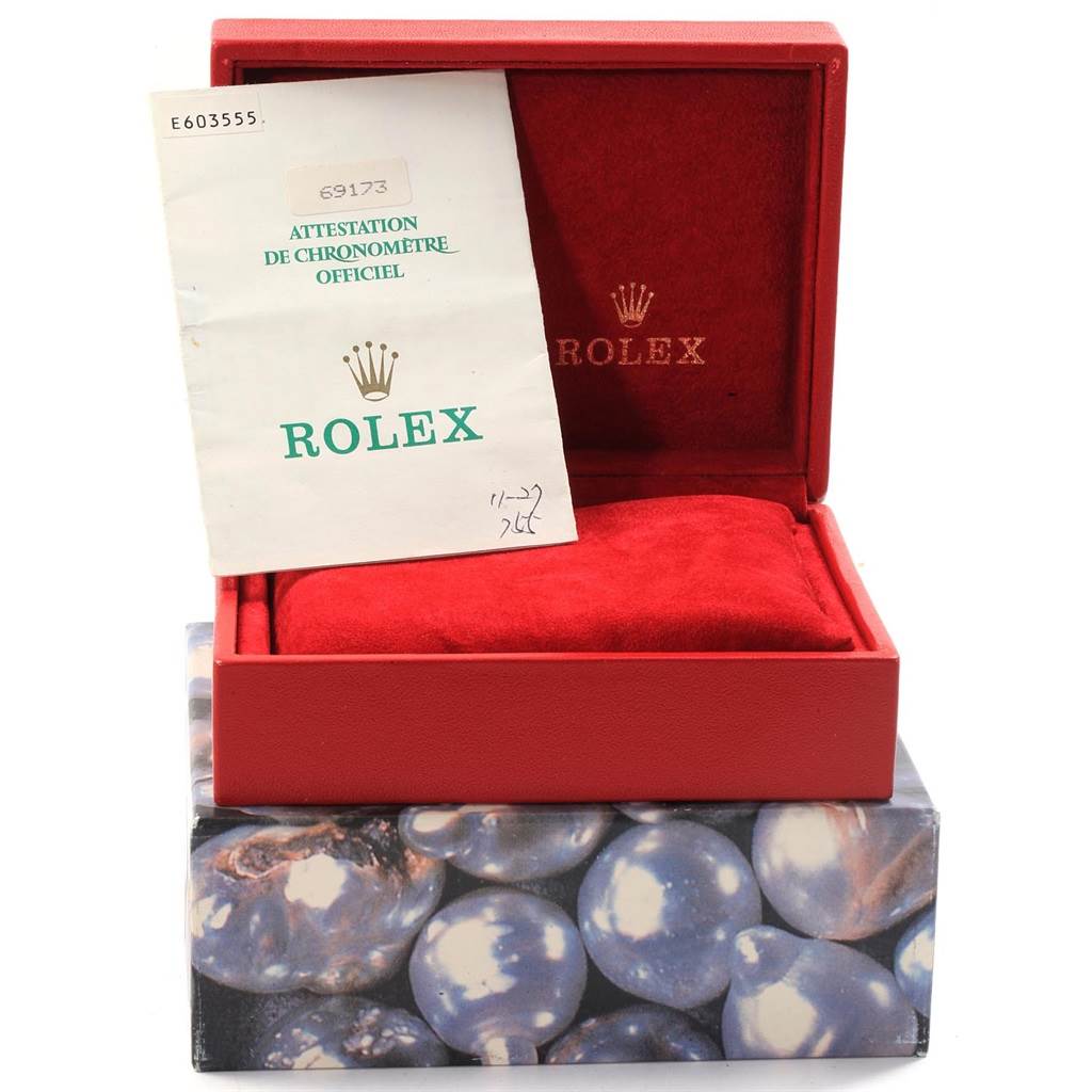 This image shows an open red Rolex box with red interior, containing documentation for a Rolex Datejust 69173 Women's Stainless Steel Beige Dial 69173 Women's Stainless Steel Beige Dial model.
