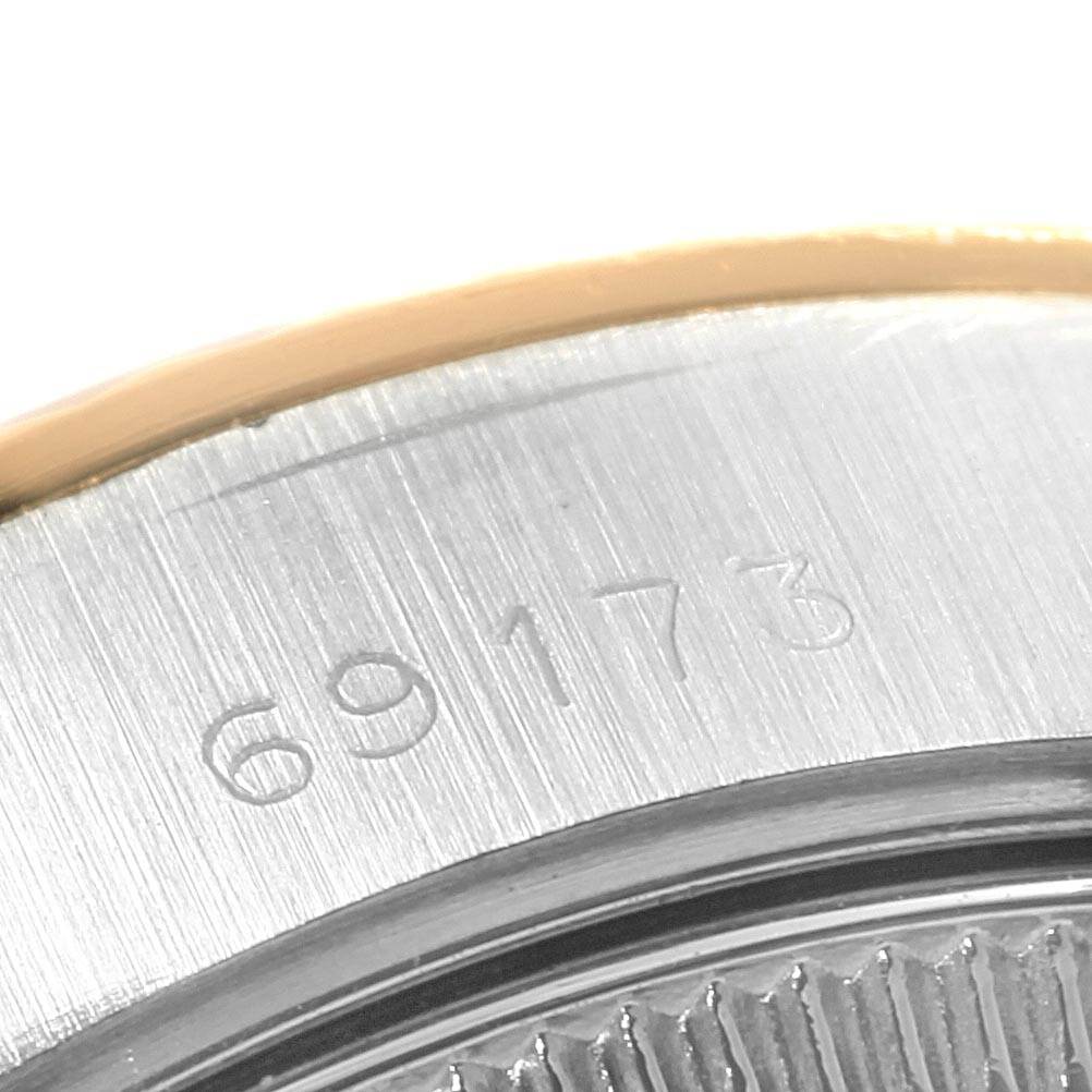 The image shows a close-up of the serial number engraved on the case back of a Rolex Datejust 69173 Women's Stainless Steel Beige Dial 69173 Women's Stainless Steel Beige Dial watch.
