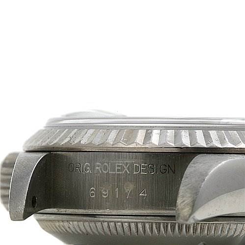 The image shows a close-up of the side of a Rolex Datejust 69174 Women's Stainless Steel White Dial 69174 Women's Stainless Steel White Dial watch case, highlighting the serial number and the crown.