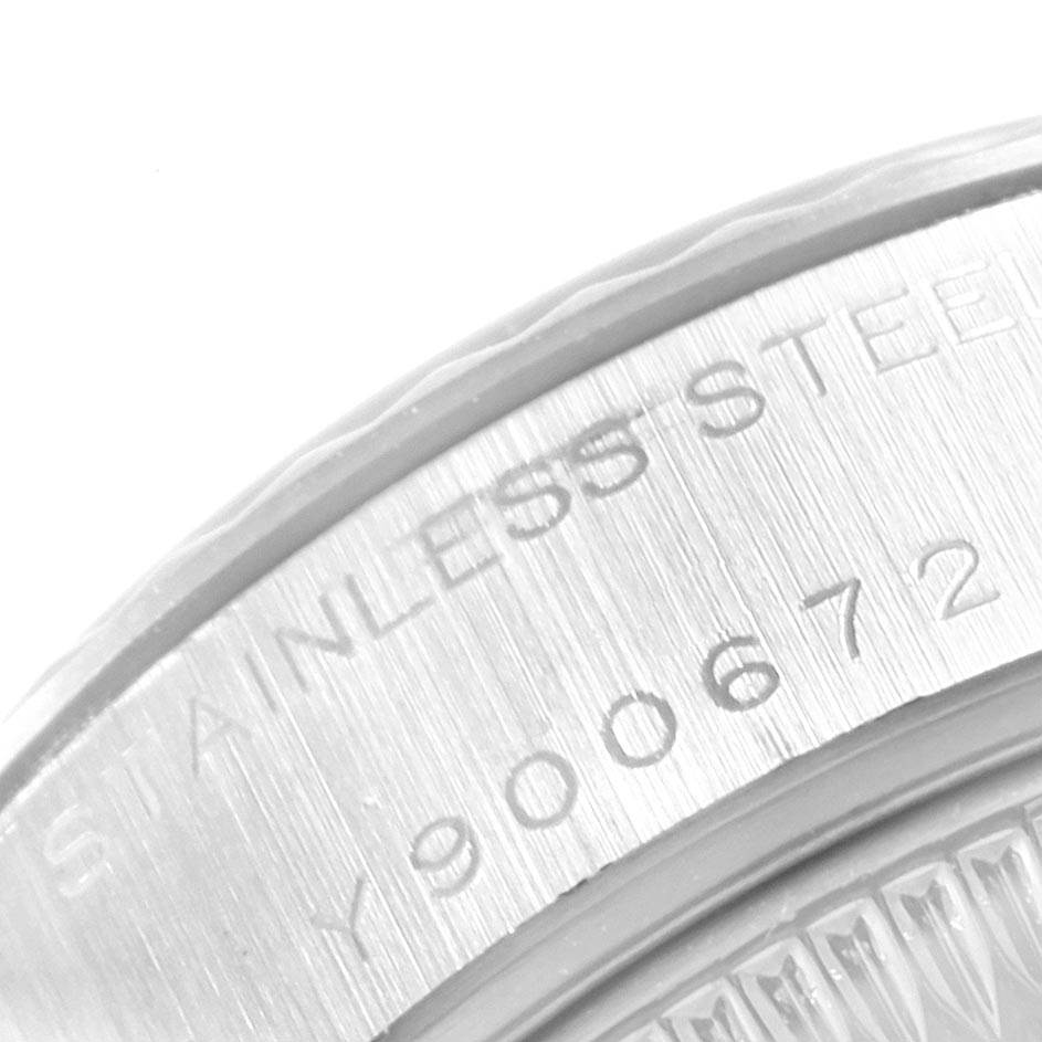 The image shows a close-up of the backside engraving of a Rolex Datejust 79174 Women's Stainless Steel Silver Dial 79174 Women's Stainless Steel Silver Dial watch, highlighting the serial number and "STAINLESS STEEL" text.