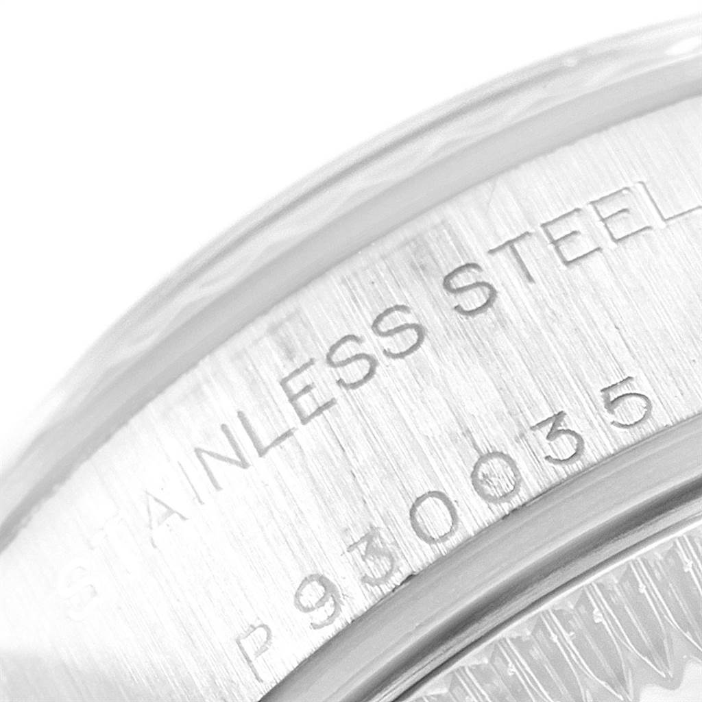 This image shows a close-up angle of the serial number and "STAINLESS STEEL" engraving on a Rolex Datejust 79174 Women's Stainless Steel Pink Dial 79174 Women's Stainless Steel Pink Dial watch case.