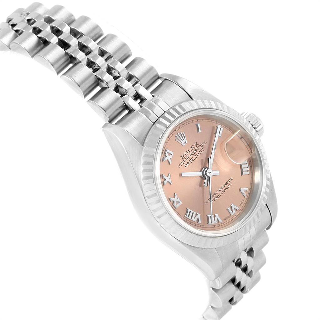 The image shows a side-angle view of the Rolex Datejust 79174 Women's Stainless Steel Pink Dial 79174 Women's Stainless Steel Pink Dial watch, featuring its bracelet, bezel, crown, and face with Roman numerals.