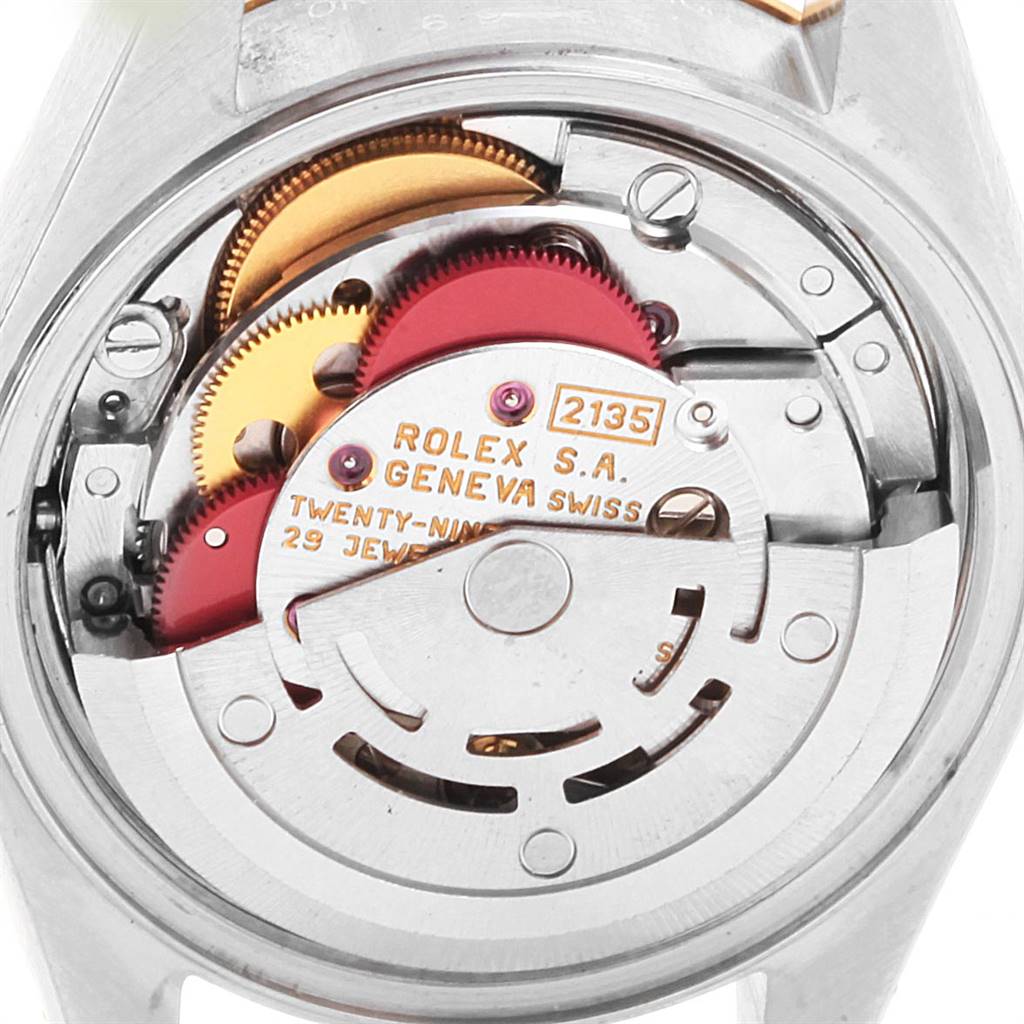 The image shows a close-up of the internal mechanism of a Rolex Datejust 69163 Women's Steel and Gold (two tone) White Dial 69163 Women's Steel and Gold (two tone) White Dial model watch, highlighting the gears and movement parts.