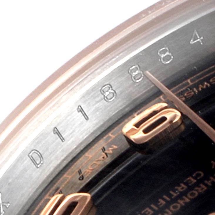 Close-up of the Rolex Datejust 179171 Women's Steel and Gold (two tone) Black Dial 179171 Women's Steel and Gold (two tone) Black Dial watch, showing part of the bezel, serial numbers, and part of the dial at an angle.