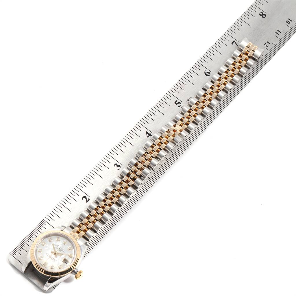 The image shows a Rolex Datejust 179173 Women's Steel and Gold (two tone) Mother of Pearl Dial 179173 Women's Steel and Gold (two tone) Mother of Pearl Dial watch lying flat with its face looking up, alongside a measuring ruler.